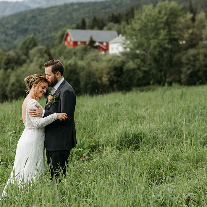 Couple photographed at golden hour in a meadow